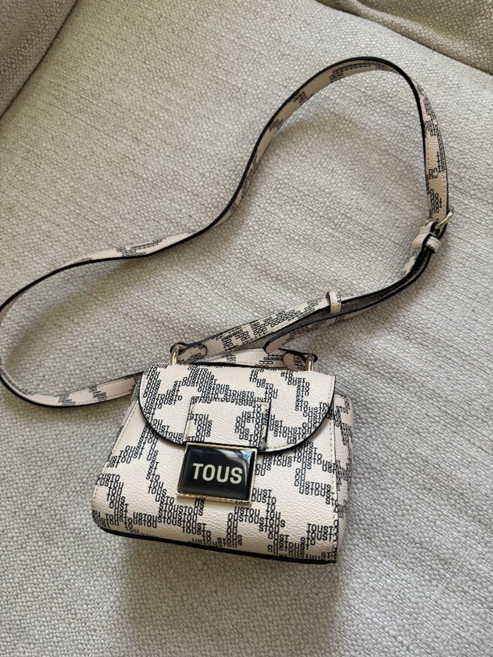 TOUS mini crossbody bag in cream/black monogram print with gold-tone hardware.